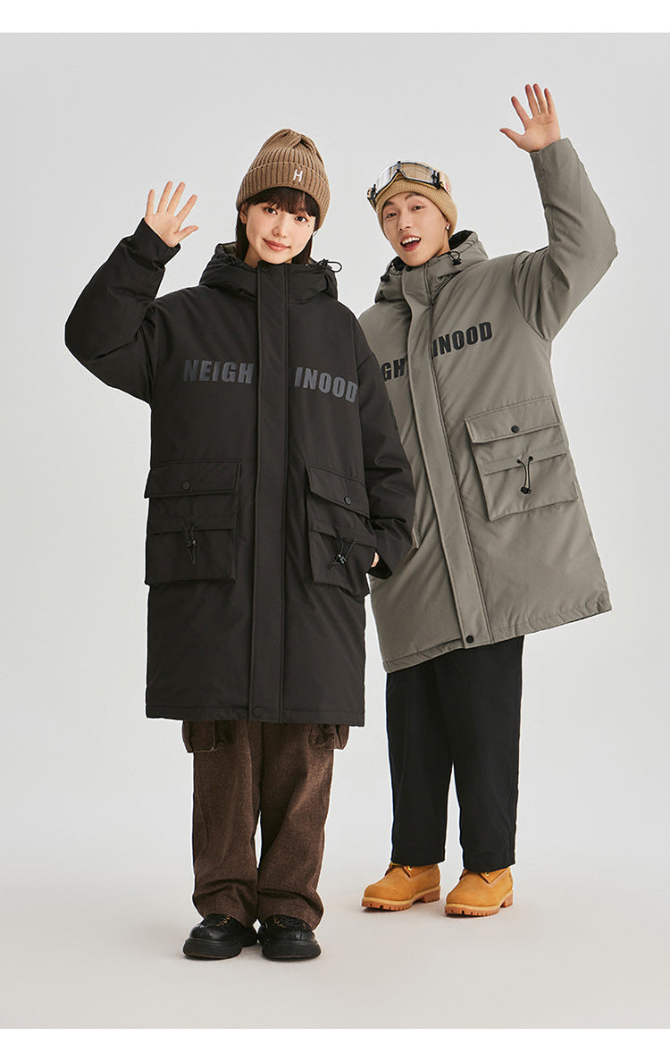 Two models wearing matching NEIGHBORHOOD parkas in black and olive green raise their hands while posing against white background