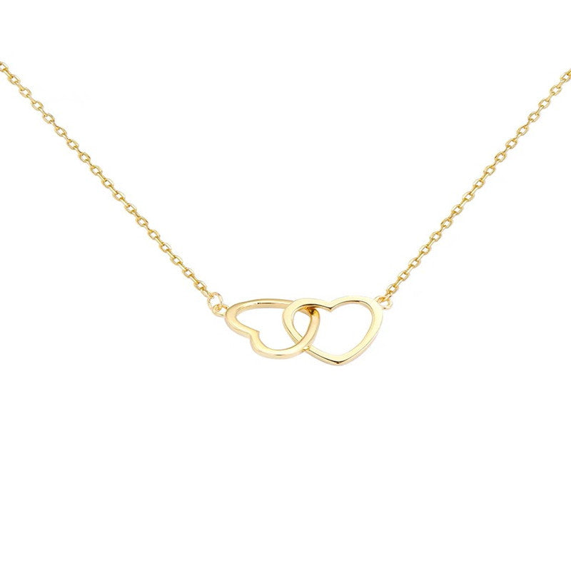 Delicate gold chain necklace with two minimalist heart-shaped pendants, shown against a light background