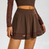 Detail view of brown mesh skirt with high waistband and double-layer hem construction