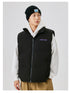 Man in black puffer vest over white hoodie with black beanie, showing contrast layering style against white background