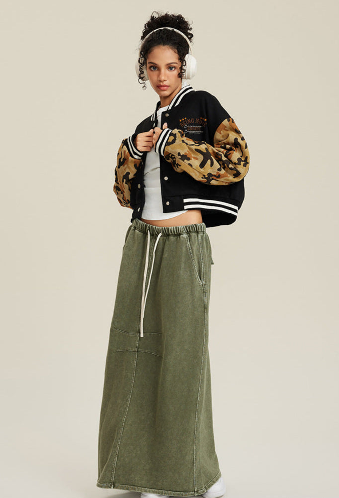 Black and tan camouflage cropped varsity jacket with white striped collar and embroidered chest design