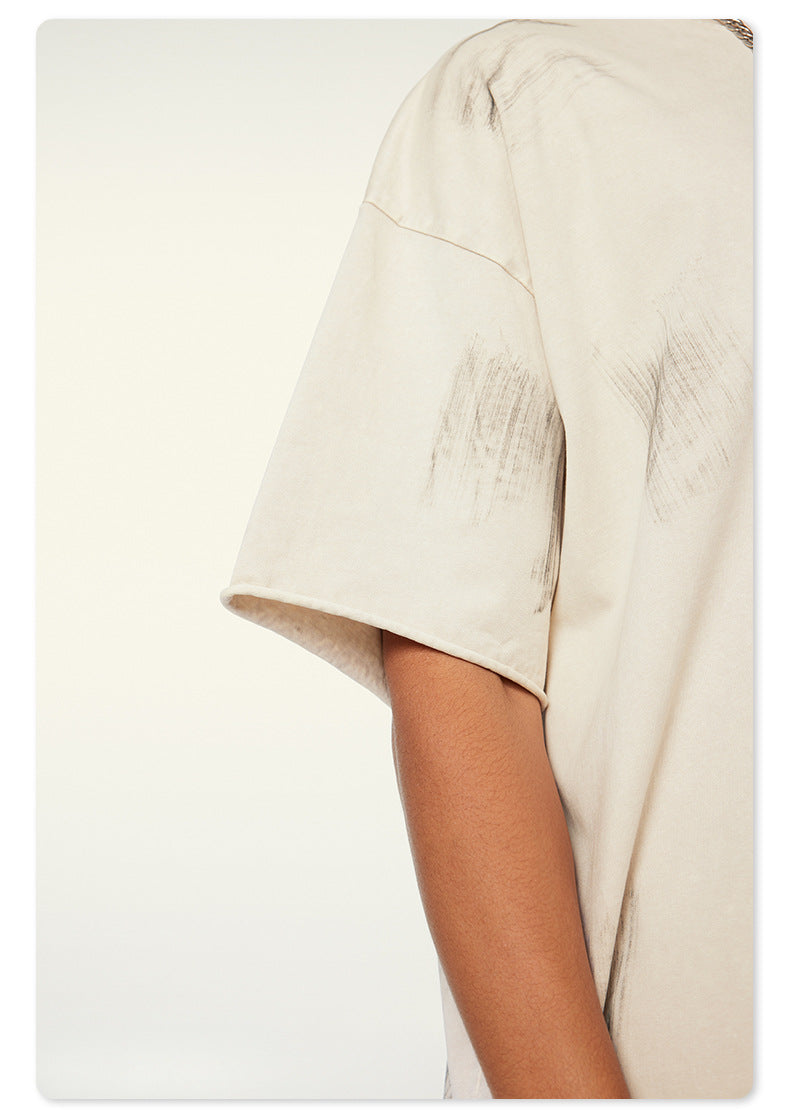 Cropped view of t-shirt sleeve showing loose, textured fabric