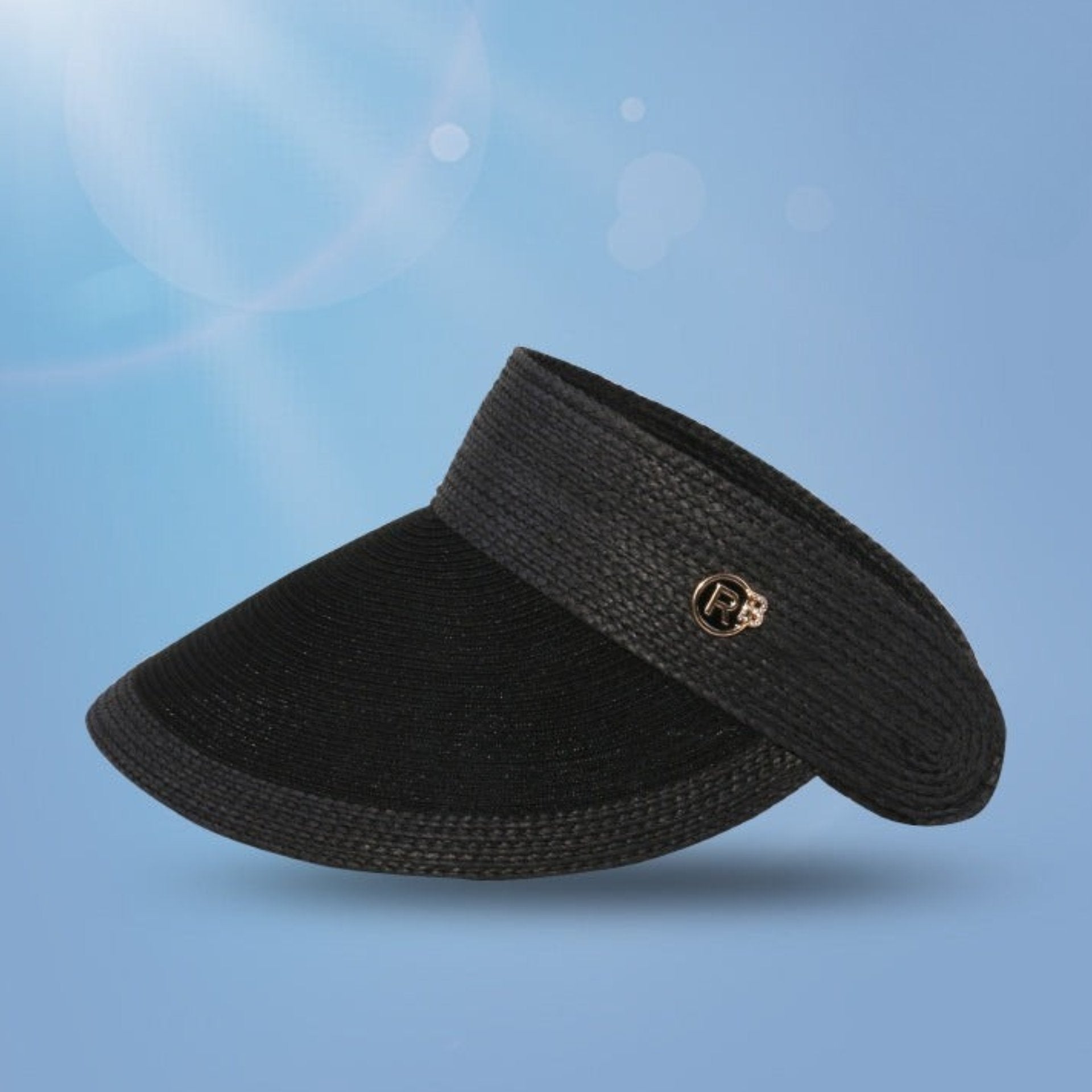 A chic black sun visor with a curved brim, featuring a metal logo charm and a UV protection badge.