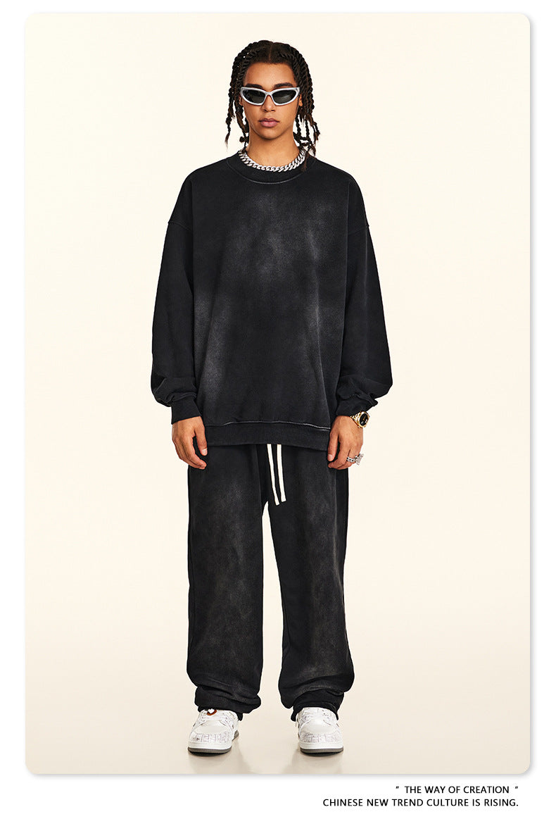 Full-length black brushed cotton sweatsuit styled with sport sunglasses and statement accessories