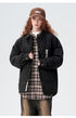 Model in black ASTROSMASH puffer jacket styled with plaid shirt, brown baseball cap and relaxed-fit pants against neutral background