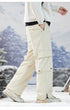 Side profile of cream cargo pants showcasing pocket placement and loose fit, styled with technical sneakers