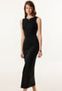 Female model in a black ribbed bodycon maxi dress, barefoot, highlighting the dress’s slim and elegant fit.
