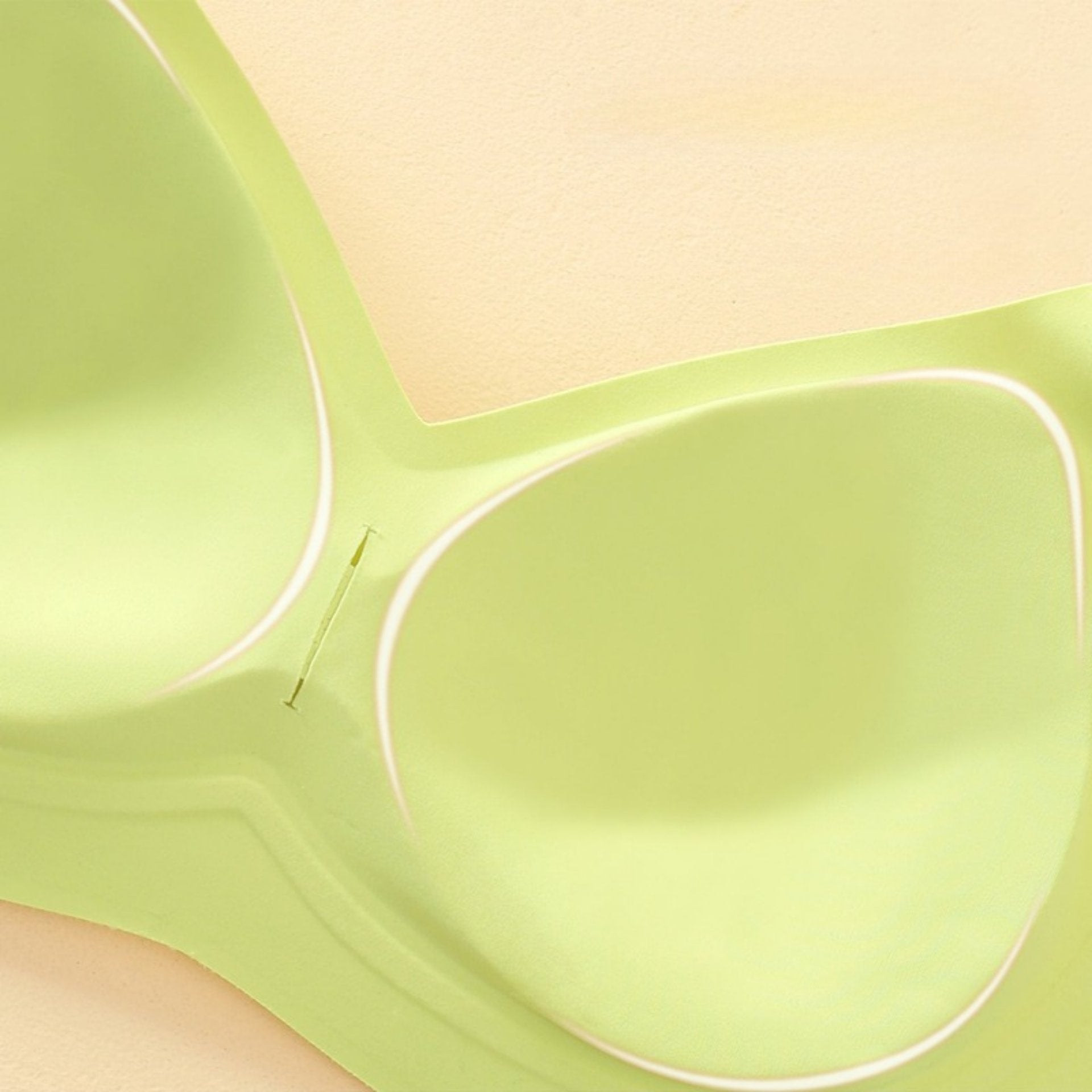 Light green seamless bra with integrated molded cups for stability.