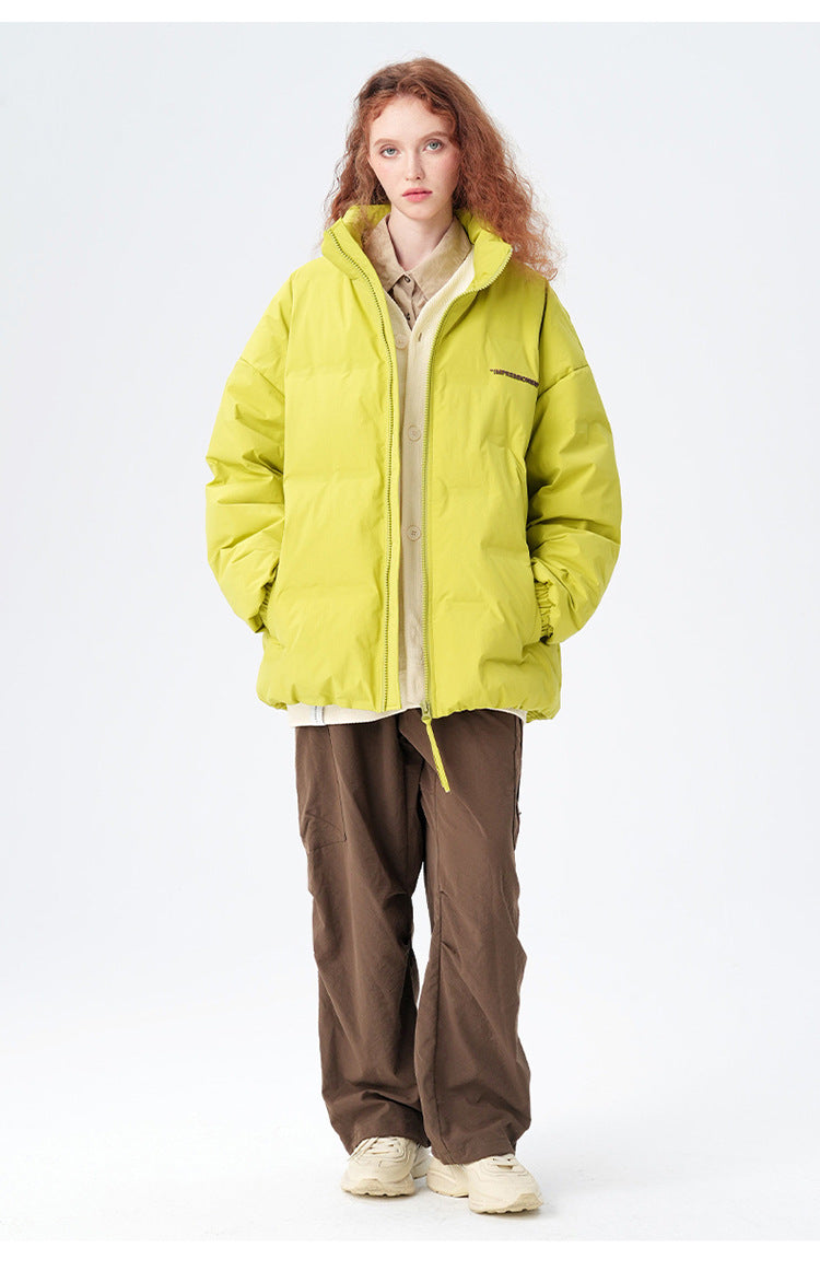 Female model showcasing yellow Impressionism puffer jacket with beige pants