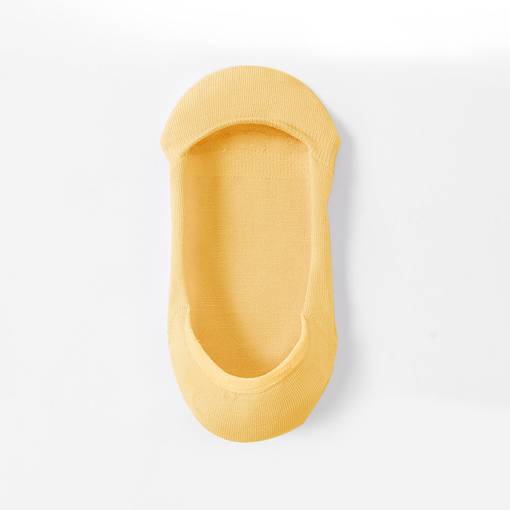 Yellow no-show sock liner photographed at wear angle, showing inner sock design
