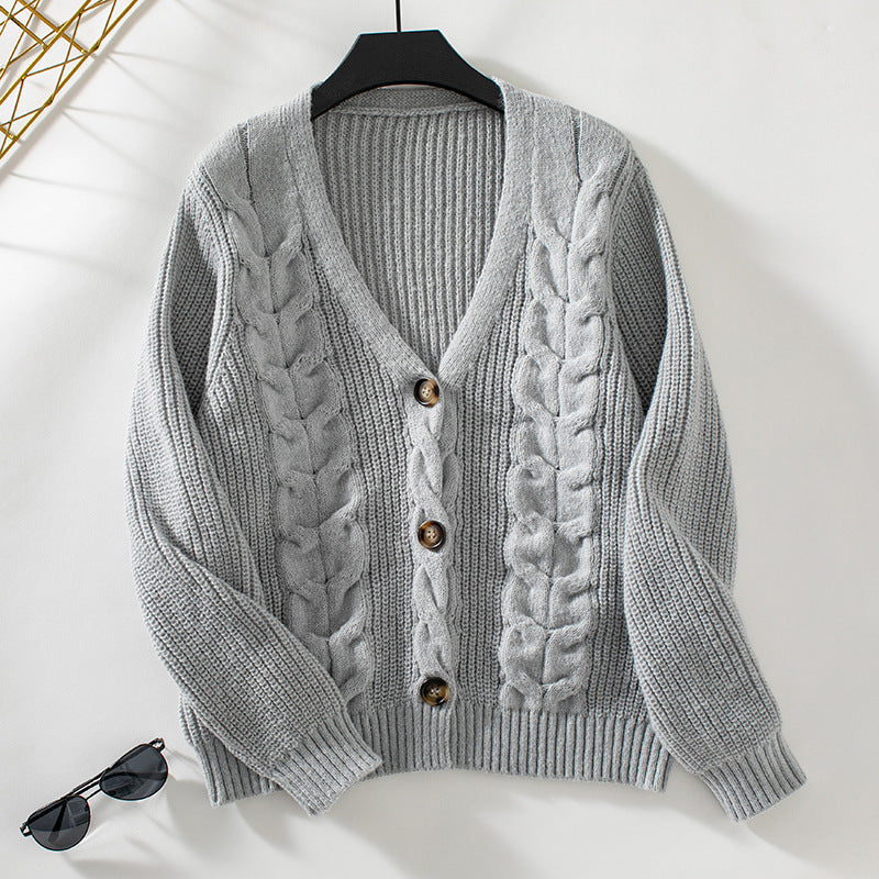 Gray knit cardigan detail showcasing cable knit texture and ribbed sleeve design