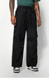 A close-up of black wide-leg pants with drawstring details, worn by a model