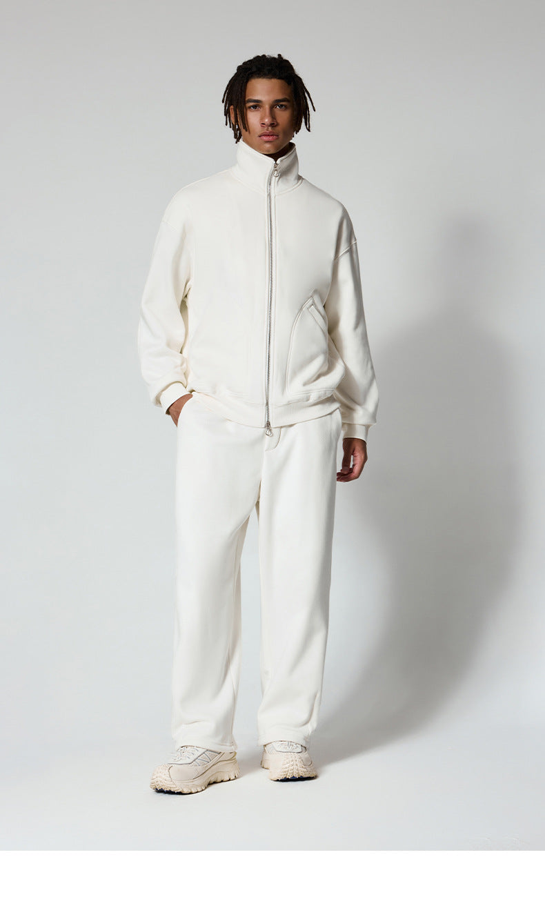 Full-length view of white track jacket and matching pants set, paired with chunky white sneakers
