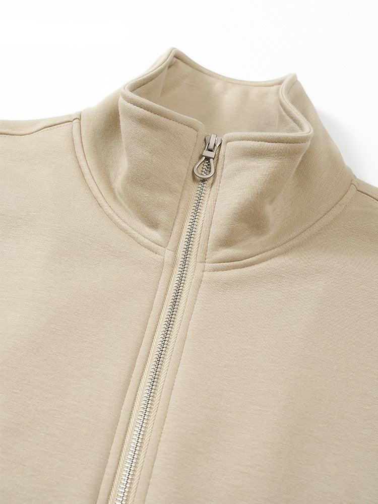 Close-up of beige track jacket's collar and zipper detailing showing quality stitching