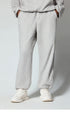 Off-white/cream sweatpants with elastic waistband, displayed flat to highlight fabric and design details