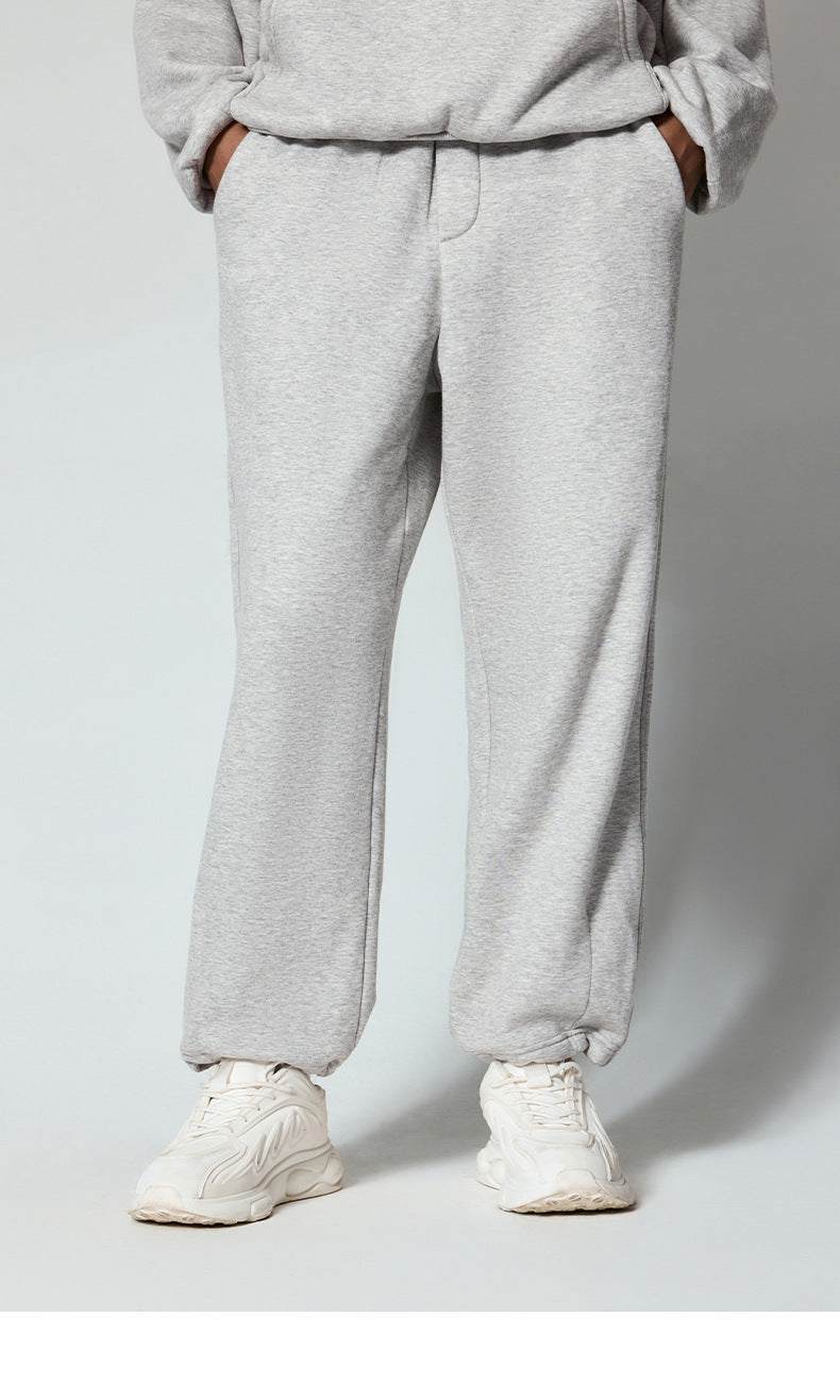 Off-white/cream sweatpants with elastic waistband, displayed flat to highlight fabric and design details