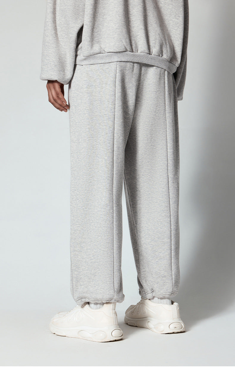 Black sweatpants with elastic waistband, shown laid flat against a white background
