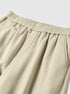 Light gray sweatpants with elastic waistband and gathered ankle, worn with white chunky sneakers