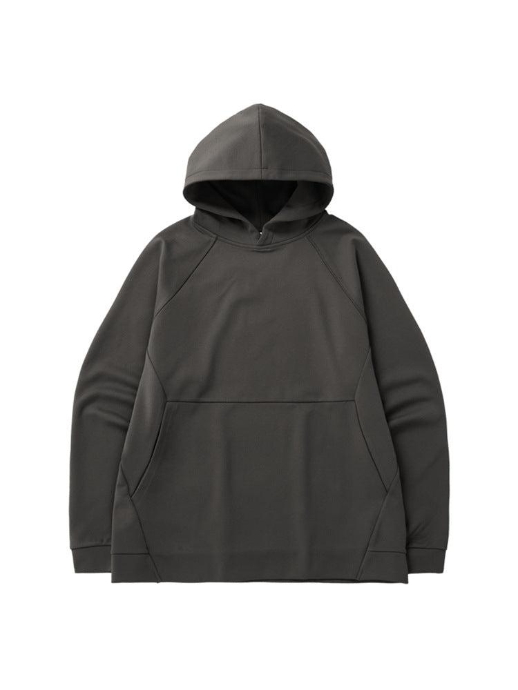 A black oversized hoodie with raglan sleeves and a front pocket displayed flat against a white background