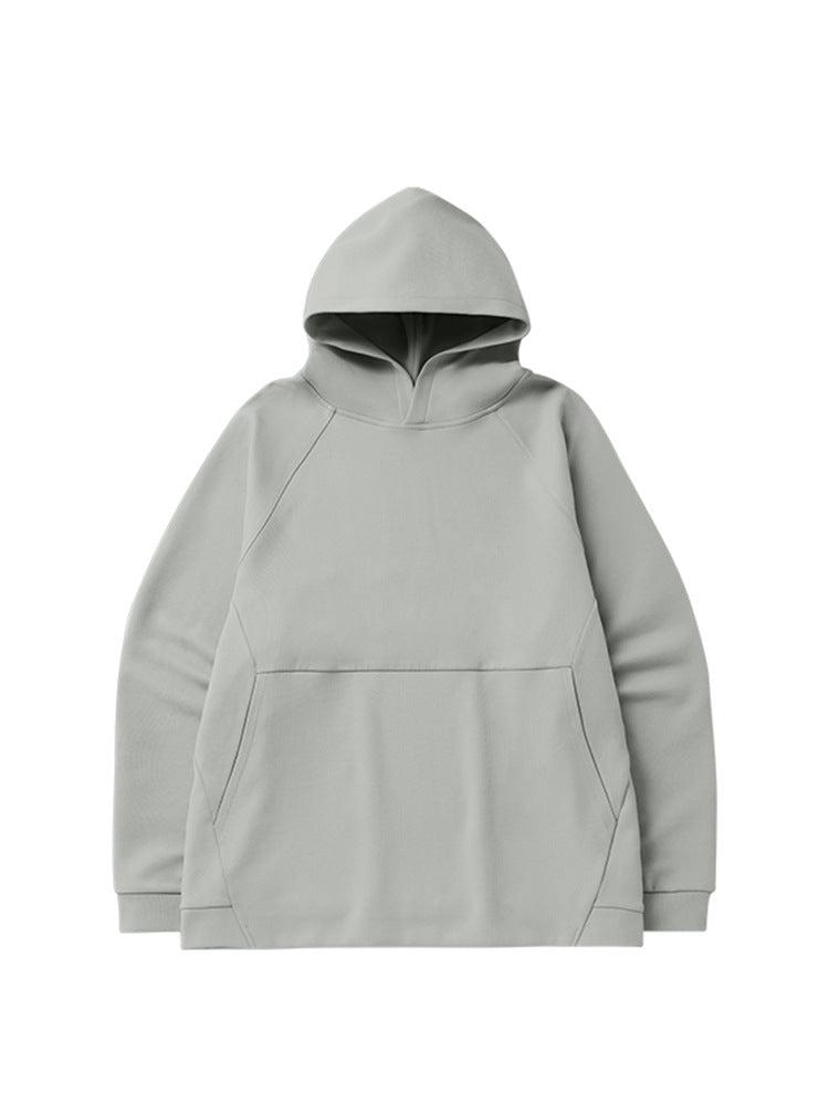 A light gray oversized hoodie with raglan sleeves and a front pocket displayed flat against a white background