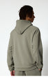 A back view of a man wearing a sage green hoodie, showing the hood and relaxed fit