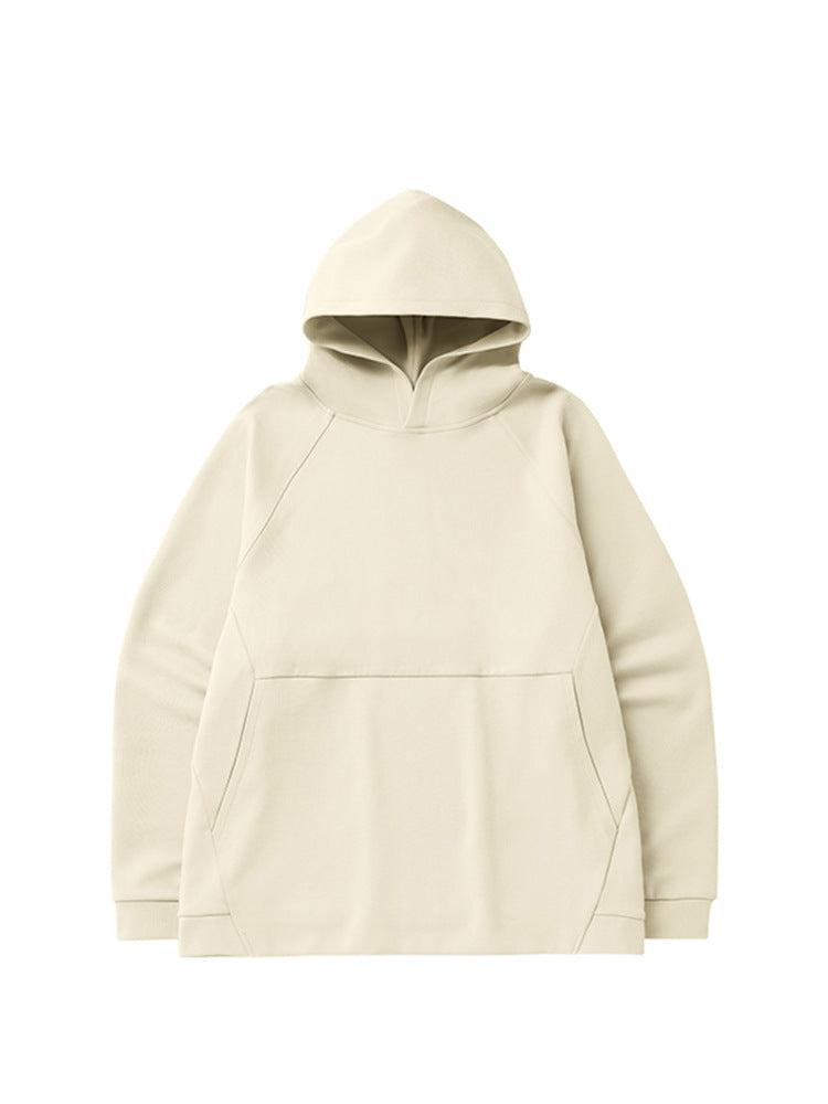 A cream-colored oversized hoodie with raglan sleeves and a front pocket displayed flat against a white background