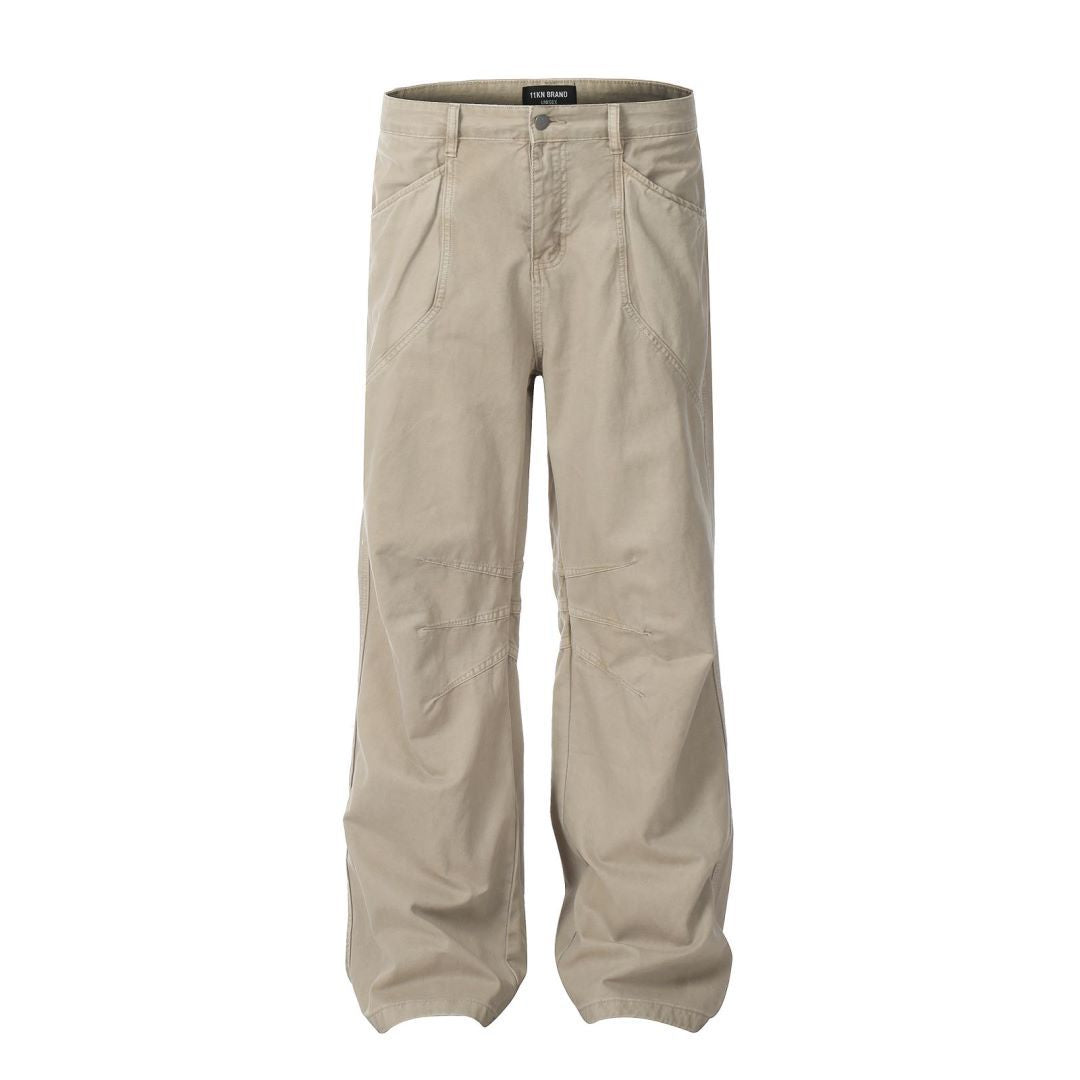ITKN brand wide-leg khaki pants with curved panel design and utility pockets, flat lay on white background