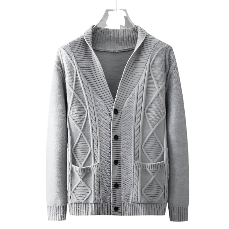 Light gray cable knit cardigan on hanger showing full front view with diamond pattern, patch pockets, and ribbed trim