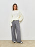 Woman in cream sweater and grey wide-leg pants, full-length fashion shot