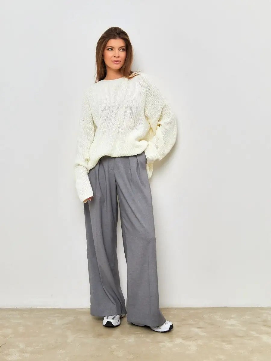 Woman in cream sweater and grey wide-leg pants, full-length fashion shot