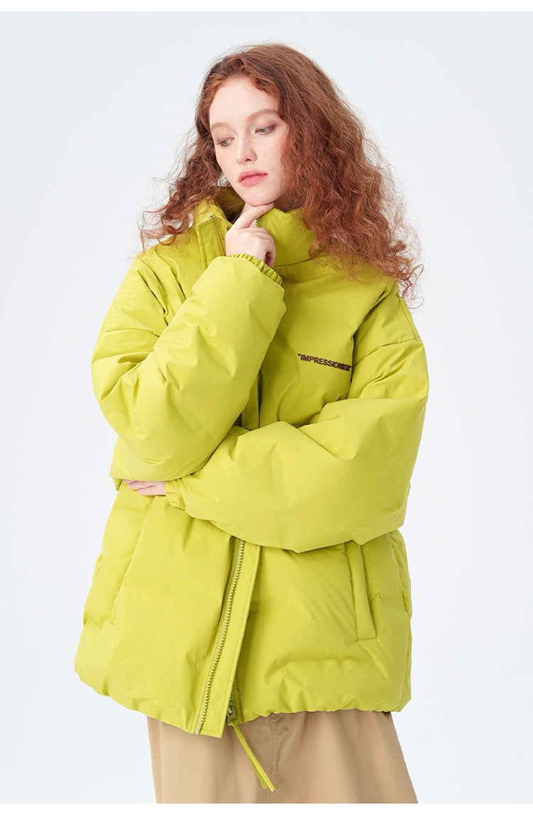 Female model showcasing yellow Impressionism puffer jacket with beige pants