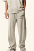 Beige sweatpants with Backstairs logo print and drawstring waist against white background