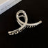  A sleek silver acrylic hair claw with a reflective glossy finish, set against a black background.