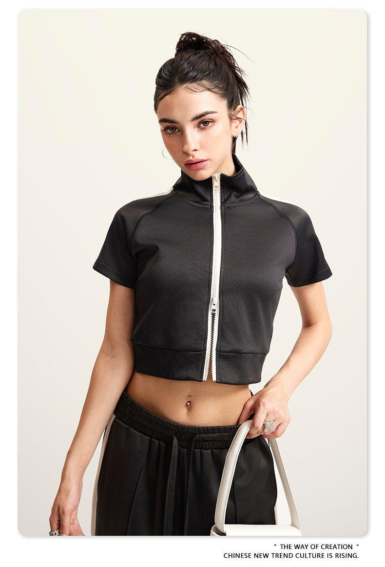 Dark gray mock neck crop top with front zip and white sleeve stripes, front view