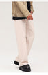 Light beige wide-leg jeans with relaxed fit, styled with dark jacket and chunky black shoes