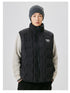 Male model in black puffer vest with high collar, white logo, cream knit sweater, gray beanie, front view against light background