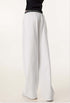 Rear view of white sweatpants, showing the relaxed fit, elastic waistband, and a single back pocket.