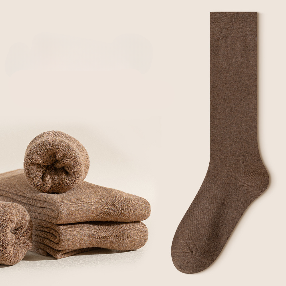 Brown knee-high sock with folded brown socks and red indicator against cream background