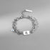 Leo zodiac charm bracelet with a bold silver-tone design, featuring a layered chain and engraved pendant.