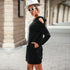 Cold-shoulder black hoodie dress with white accessories, capturing chic street style aesthetic