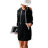 Black hoodie dress with cut-out shoulders, styled with white hat for modern casual look