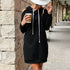 Close-up of black hoodie dress with white drawstrings, emphasizing comfortable fabric details