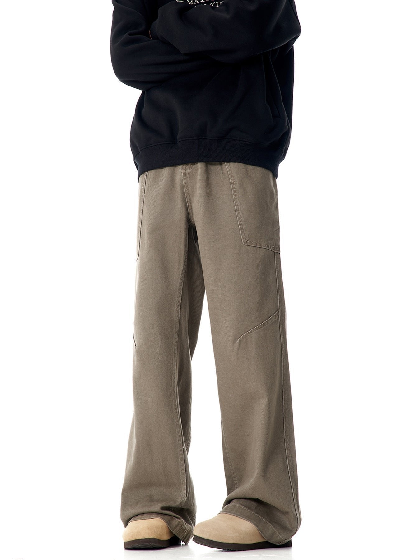 Model wearing olive wide-leg pants with utility pockets, styled with black sweatshirt