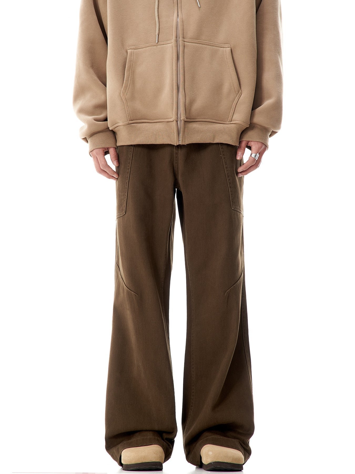 Wide-leg cargo pants in brown with diagonal seams, shown with beige sweatshirt and boots