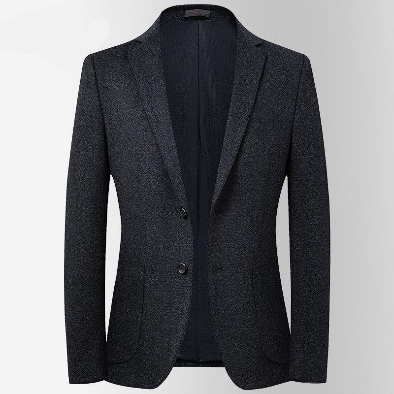 A dark gray textured blazer with single-button closure displayed on mannequin. Slim fit design with subtle wool texture against light backdrop