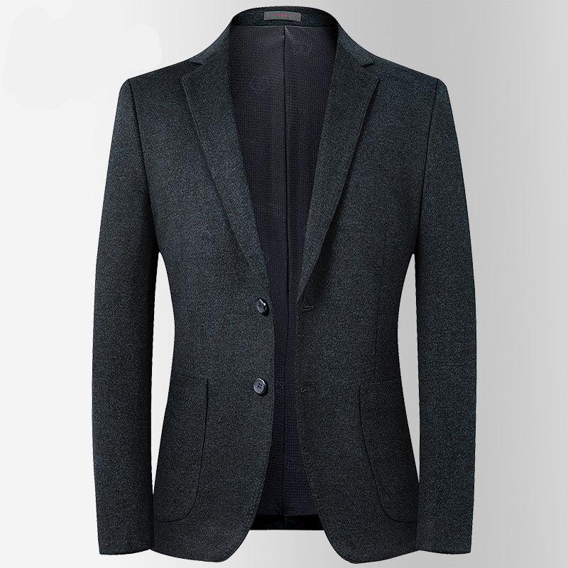 A charcoal two-button blazer displayed open showing inner lining. Tailored silhouette with patch pockets and minimal styling details