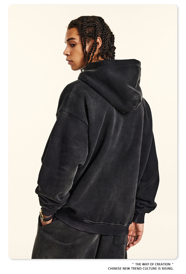 Side profile showing plain black hoodie back and braided hairstyle
