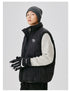 Back view of male model in black puffer vest showing Neightrainood 20XX embroidery, gray beanie, cream sweater, hands in pockets