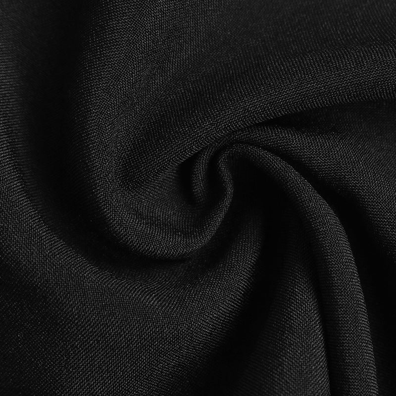Close-up of black fabric with a slight sheen, swirled to show texture.