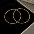 Gold thin hoop earrings in black jewelry box